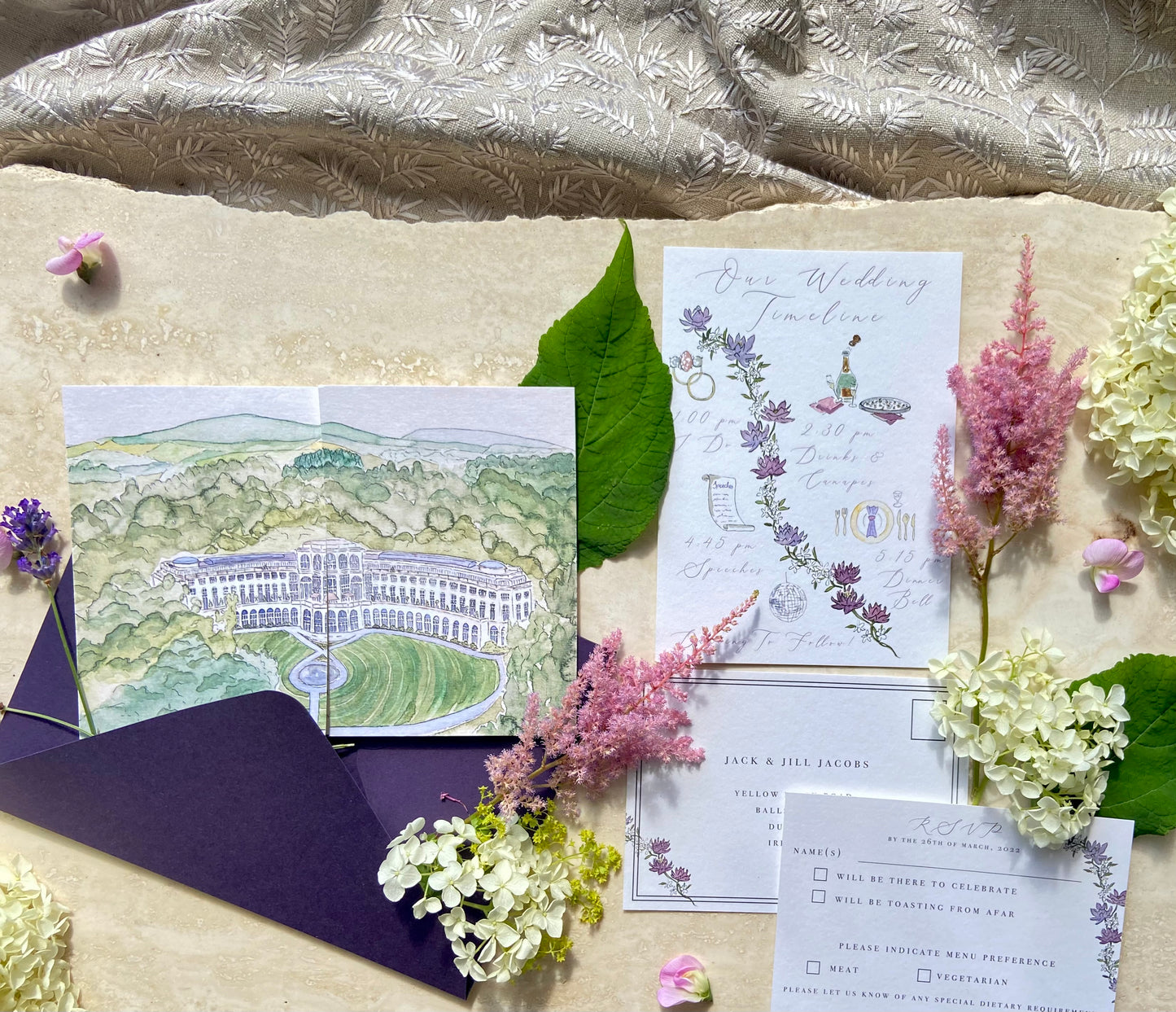 A wedding invitation suite featuring a gatefold invitation with a watercolour illustration of Powerscourt Hotel, and amethyst envelope, by Hannah Blake Art